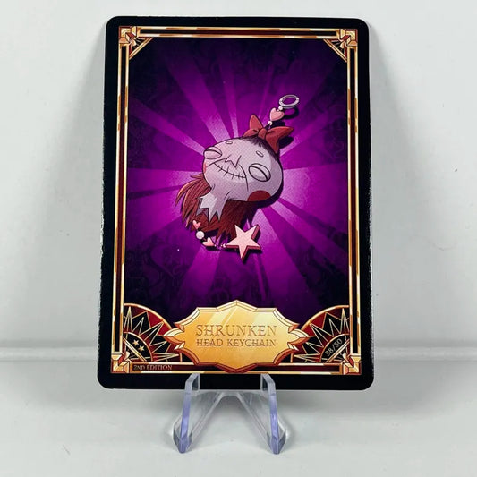 Carte Hazbin Hotel 38/50 :  SHRUNKEN HEAD KEYCHAIN